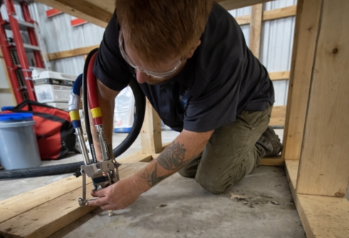 LUX concrete specialists lifting an uneven floor using polyurethane injection to restore the damaged concrete slab surface.