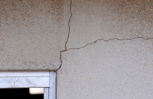 Diagonal and horizontal drywall cracks spreading from the upper door frame corner, a sign of drywall cracks in Berkeley, WV.