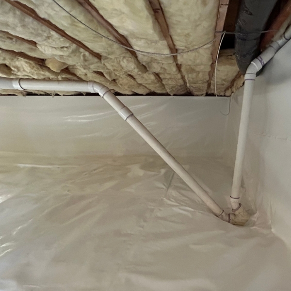 Crawl space waterproofing with sealed vapor barrier and drainage piping, a crawl space repair solution in Bristow, VA.