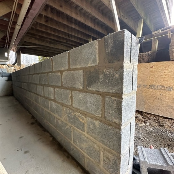 New concrete block foundation wall replacement, restoring structural support as a foundation repair solution in Ashburn, VA.