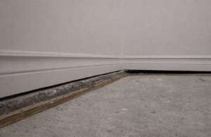 Visible gap between basement slab and foundation wall along base trim, a sign of a sinking concrete slab in Berryville, VA.