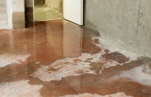 Water pooling and seepage on uneven basement floor in low spots, a sign of an uneven basement floor in Front Royal, VA.