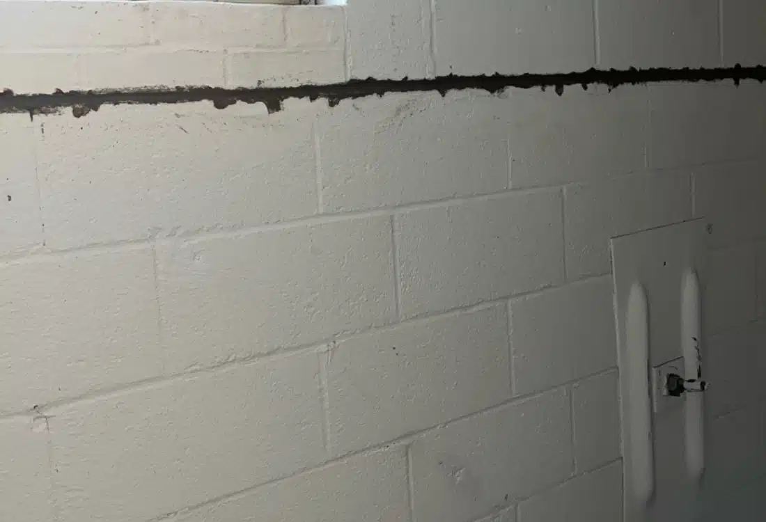 Installed Grip-Tite wall plates across the interior front foundation wall after wall anchor system installation in Leesburg, VA.