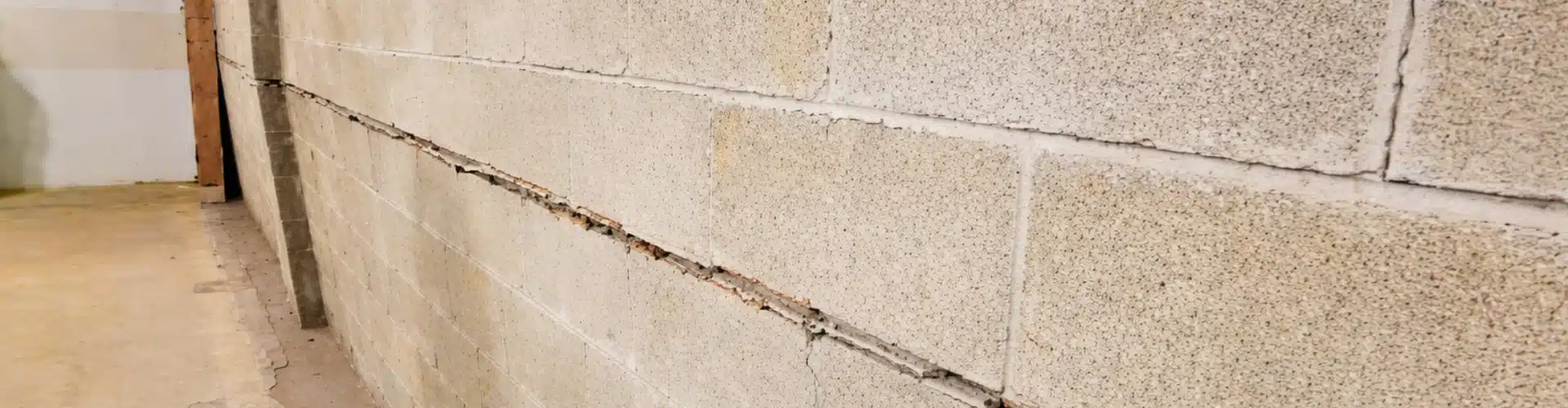 Severe bowing foundation wall in Northern Virginia with horizontal crack and displaced block.