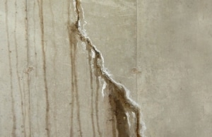 Water seeping through a large vertical crack, a sign of cracks in the concrete wall in Gainesville, VA.