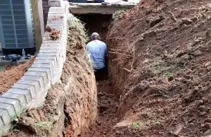 An expansive clay soil excavated beside foundation wall, causing pressure, a sign of basement wall bowing in Gainesville, VA.