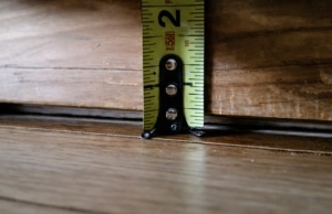 Measuring tool showing a visible gap between the floor and wall, a sign of cracks in the concrete wall in Clear Brook, VA.