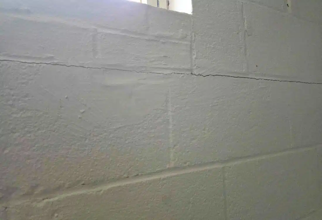Horizontal crack running the full length of a CMU foundation wall in a Leesburg, VA, basement — caused by lateral soil pressure.