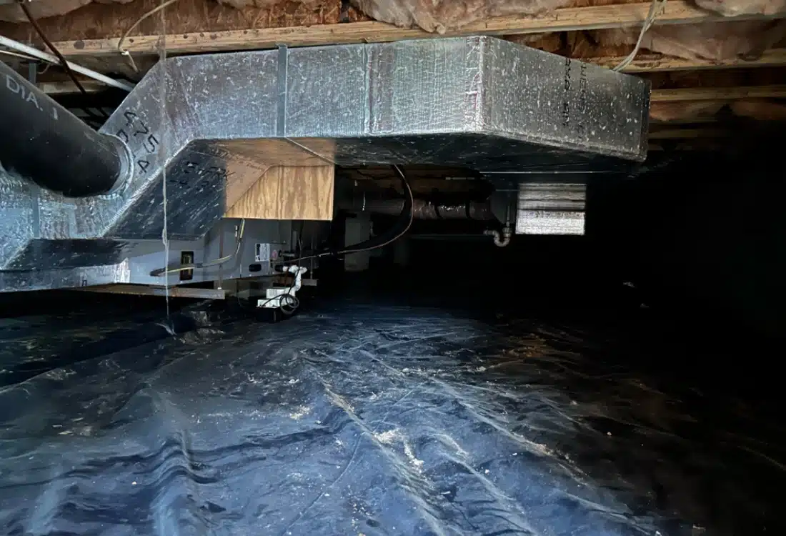 Unsealed crawl space showing torn black plastic liner, and exposed soil before crawlspace encapsulation in Luray, VA