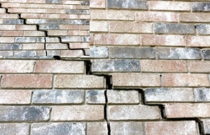 Stair-step crack on brick basement wall showing mortar joint separation, a sign of bowing basement wall in Reston, VA.