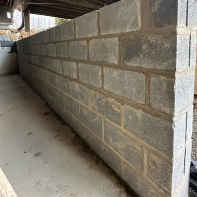 Newly rebuilt straight concrete block foundation wall in crawl space, a bowing foundation wall repair in Flint Hill, VA
