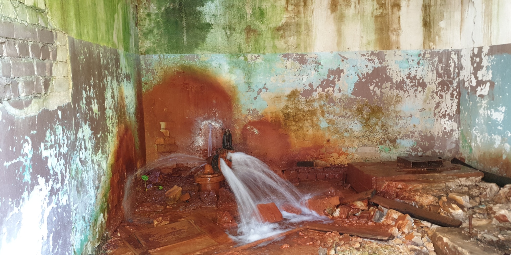 A major water leak in crawl space in Northern Virginia, where plumbing releasing water against foundation walls.