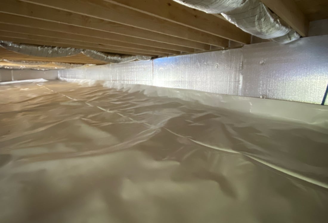 Encapsulated crawl space in Shenandoah, VA, with white vapor barrier and radiant barrier insulation panels on foundation walls.
