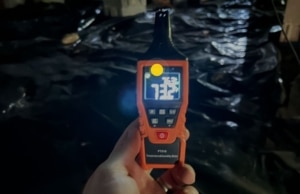 ygrometer reading 73 percent high humidity levels inside a dark crawl space, a sign of mold in crawl space in Stephens City, VA.