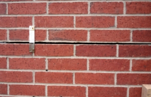 Horizontal crack running along a single mortar joint on a brick wall, indicating a potential mortar crack problem in Berkeley, WV.