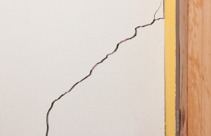 Diagonal crack on interior drywall beside a door frame, a sig of foundation movement and mortar crack in Front Royal, VA.