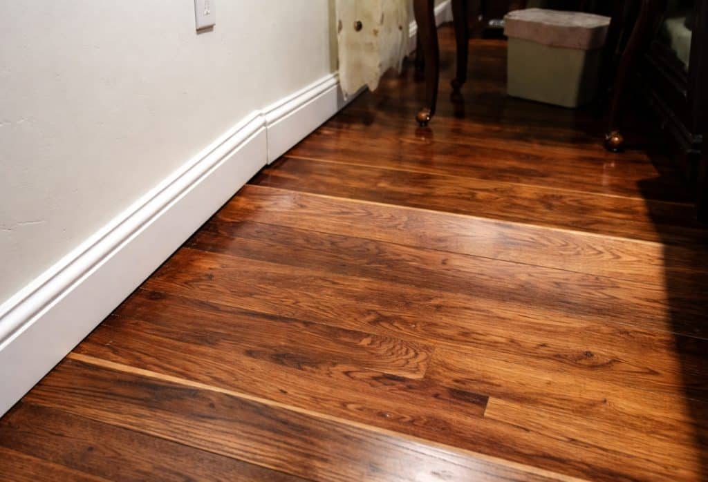 Warped, buckled hardwood flooring found during a basement inspection checklist walkthrough in Winchester, VA.