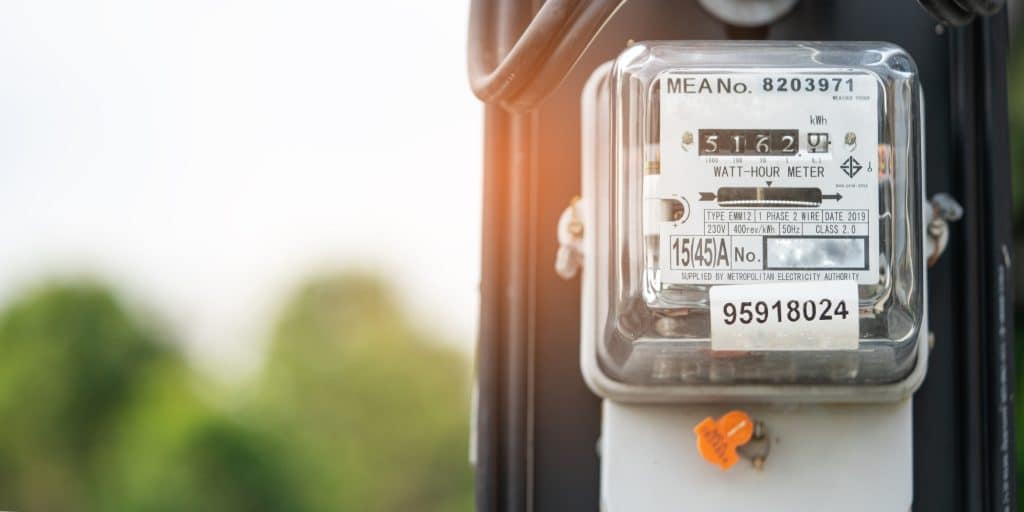 Close-up of a residential electric meter showing high energy costs linked to an unsealed crawl space in Northern VA.