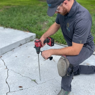 LUX team concrete caulking with Polyflex as part of garage floor crack repair to seal a cracked garage floor in Berkeley, WV.