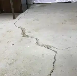 Concrete basement floor showing irregular shrinkage crack caused by during curing process in Martinsburg, WV.