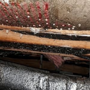 Condensation forming on ductwork and pipe causing wood rot decay conditions in Brambleton, VA.
