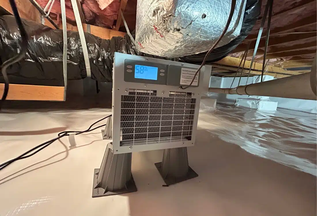 Crawl space dehumidifier installed in an encapsulated crawl space to maintain humidity and reduce energy costs in Alexandria, VA.