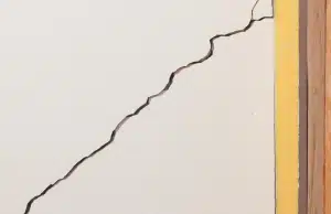 Diagonal crack spreading from corner of finished basement wall, sign of cracks in basement wall problem in Reston, VA.
