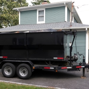 Heavy dumpster trailer parked on a residential driveway causing cracked driveway in Southbridge, VA.