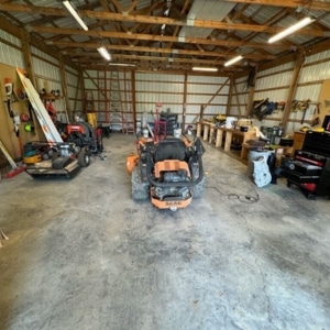 Heavy equipment and machinery on a large garage concrete floor showing vehicle stress damage and cracking in Clear Brook, VA.