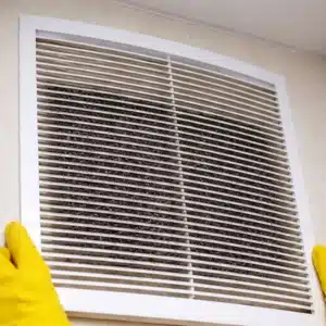 Heavily clogged basement air vent blocked with dust and debris, causing musty smell in basement in Charles Town, WV.