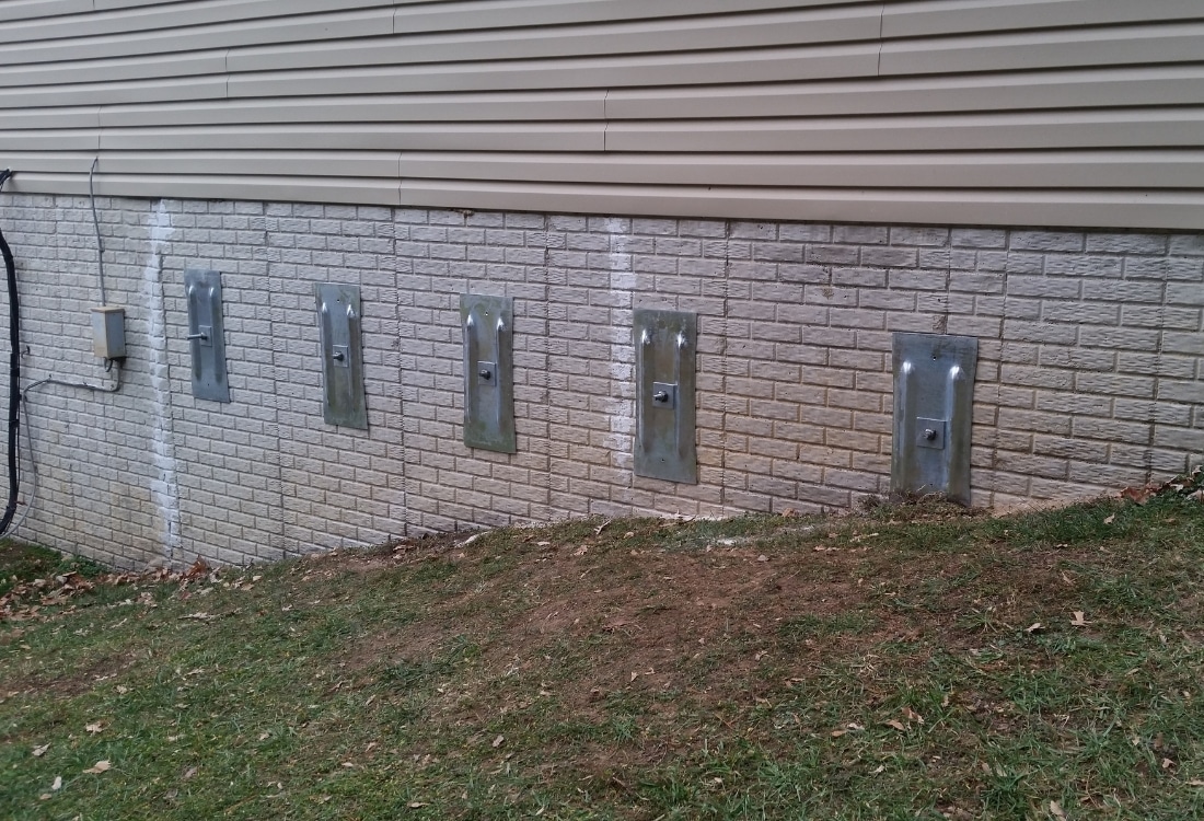Completed foundation wall anchor installation showing professional foundation repair work that protects home value in Winchester, VA.