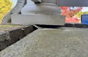 Shifted concrete porch section showing uneven slab settlement and gap between slabs from sinking porch problem in Alexandria, VA.