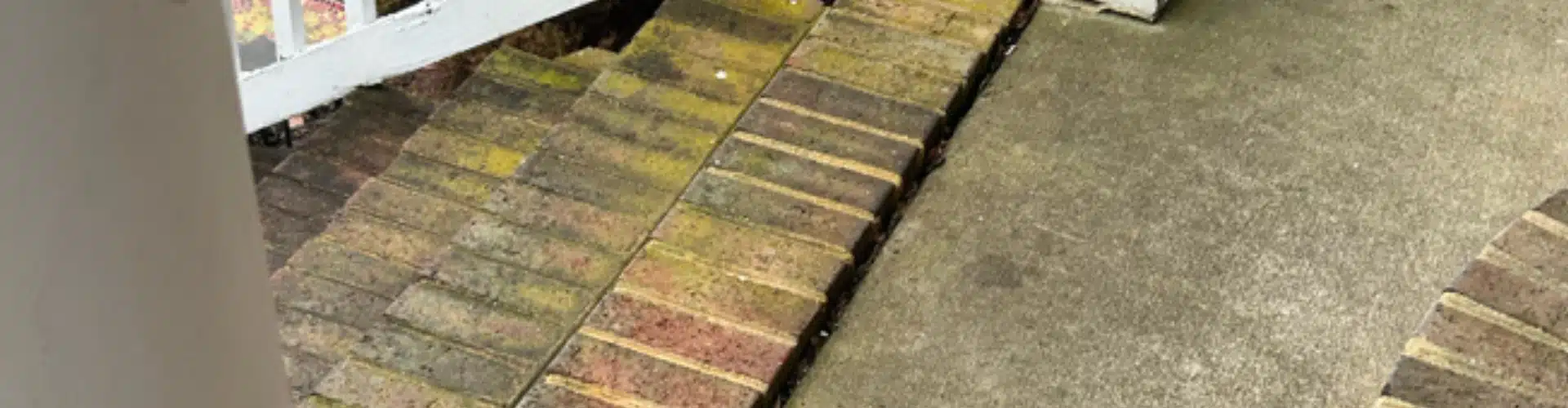 Brick porch step dropping away from concrete surface needing sinking porch repair in Winchester, VA.