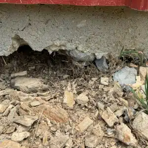 Soil settlement and erosion beneath house foundation causing cracks in basement floor in Warrenton, VA.