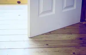 Interior door that sticks and not close due to frame distortion, a sign of cracks in basement floor problem in Stephens City, VA.