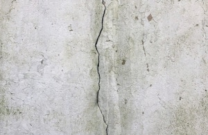 Vertical crack running down concrete basement wall, sign of cracks in basement wall problem in Fairfax, VA.