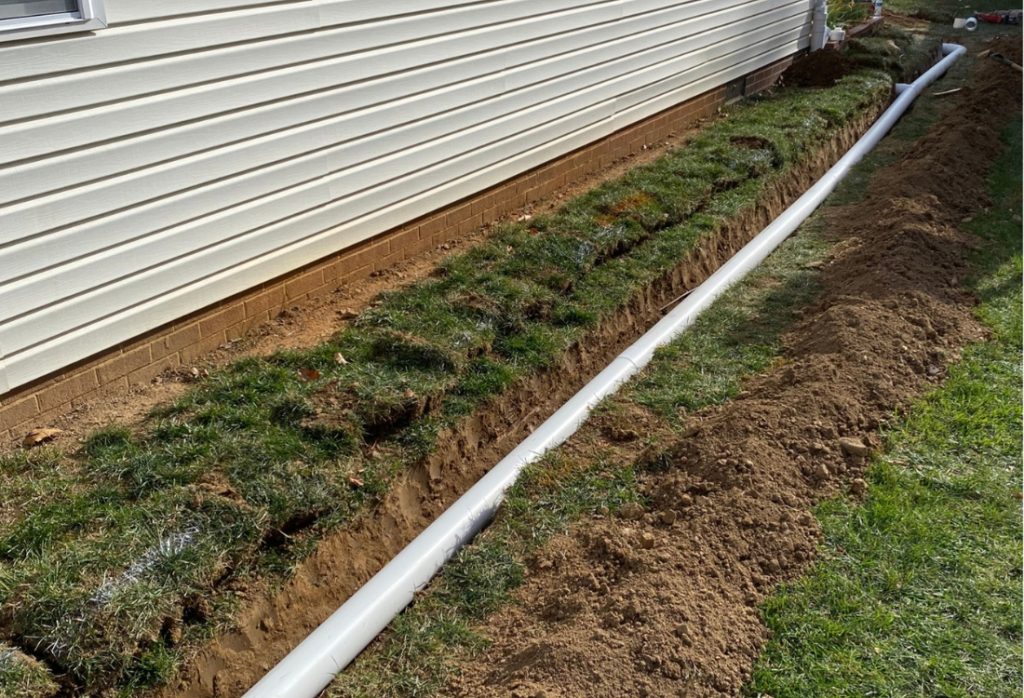 French drain blended into landscaping with gravel and plantings, one of the benefits of French drain installation in White Post, VA.