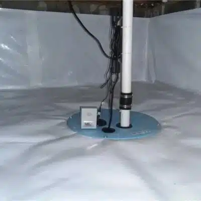 Installed crawl space drainage system beneath residential homes to redirect groundwater and in Southbridge, VA.