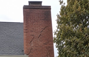 Large diagonal crack running through chimney brick face, a sign of cracks in chimney bricks problem in Bristow, VA.