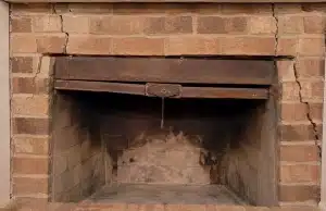 Stuck fireplace damper with diagonal cracks on both sides of the firebox, sign of cracks in chimney bricks problem in Clear Brook, VA.