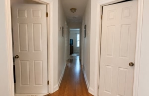 Two doors in the same Northern Virginia home hallway both showing gaps and misalignment, a sign of sticking doors in Berkeley, WV.