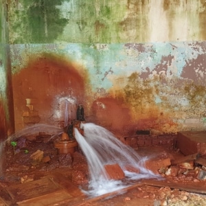 Severely corroded bursting pipe leaking water and raising crawl space humidity levels in Flint Hill, VA.
