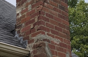 Deteriorated chimney with crumbling mortar and recurring crack patterns, a sign of cracks in chimney bricks problem in White Post, VA.