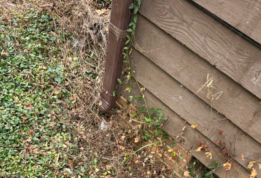 Short downspout discharging roof runoff too close to the foundation and crawl space of a home in Culpeper, VA