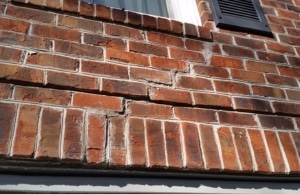 Stair-step crack through brick mortar joints, a sign of uneven foundation settlement problem in Stephens City, VA.