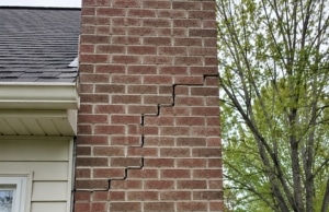 Stair-step crack running through chimney brick mortar joints, a sign of cracks in chimney bricks in Brambleton, VA.