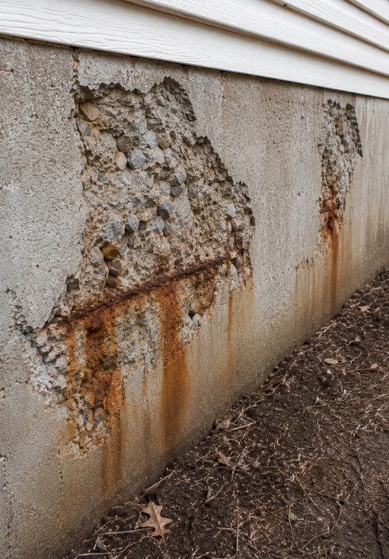 Concrete surface breaking away from home foundation wall, needing foundation repair assessment in Winchester, VA.
