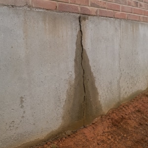 Foundation wall crack with water seeping through that causes high electric bills in Berryville, VA.
