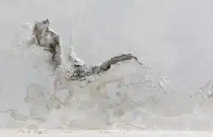 Dark mold staining exposed behind peeling paint, sign peeling or bubbling paint on basement walls in Fairfax, VA.