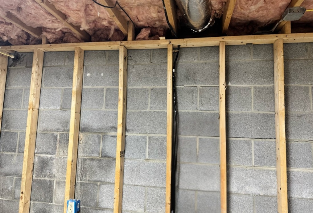 Cracked concrete block foundation wall with horizontal cracking before carbon fiber strap repair in Winchester, VA.